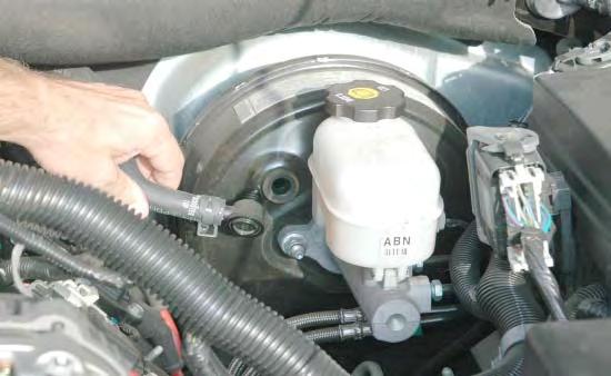 28. Remove the power brake hose and check valve