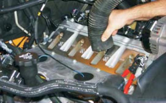 radiator, loosen the two bolts that secure the thermostat assembly with a 10mm socket wrench.