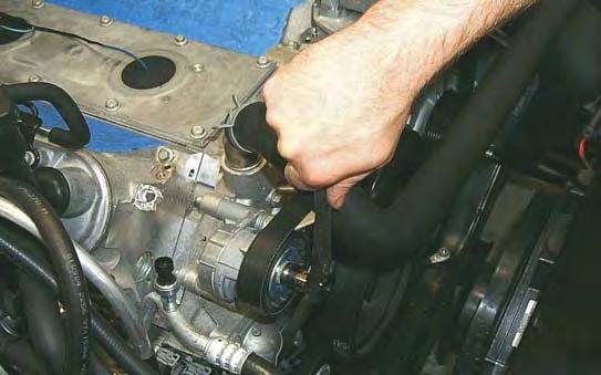 Using a 15mm tensioner wrench or breaker bar, remove the stock