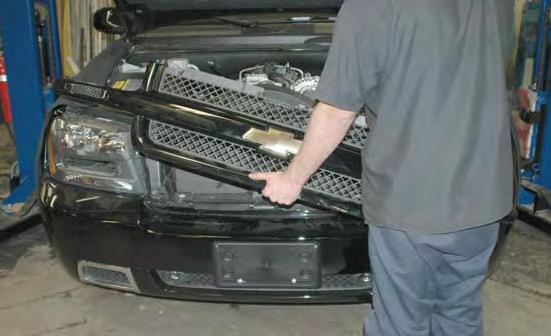 Remove the front grille assembly by CARE- FULLY pulling out on it