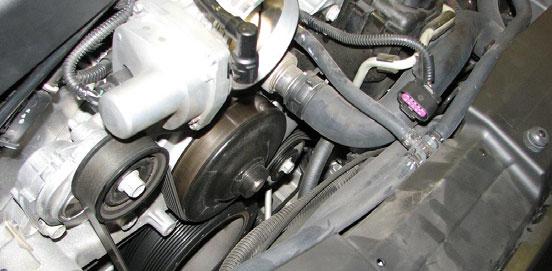 20. Use a 15mm socket and a breaker bar to turn the tensioner until the serpentine belt has enough slack to