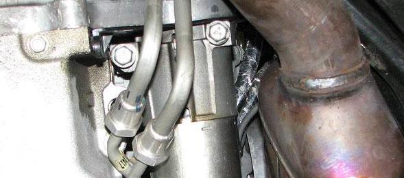 Use the pry bar to widen the gap when needed and push the brake lines out of the way to clear the gearbox.