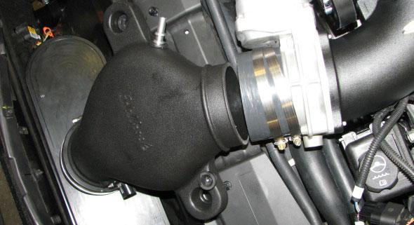 Connect the passenger side PCV hose to the air inlet tube fitting, then route the hose along the passenger side valve cover and