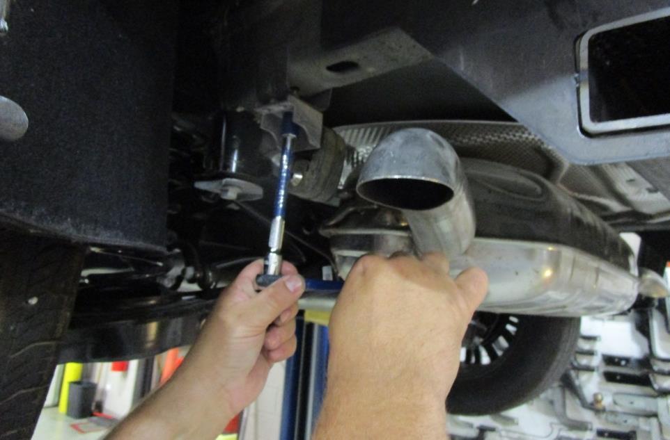 Re-install exhaust - Raise exhaust into position, install the bolts removed from the hangers