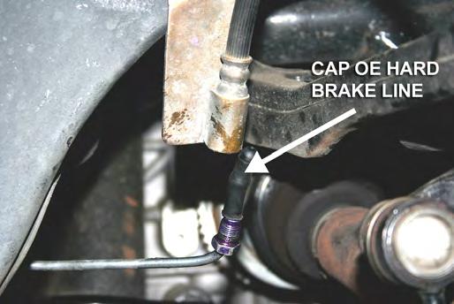 Unscrew the flare nut on the brake hard line with a flare nut wrench to avoid rounding the