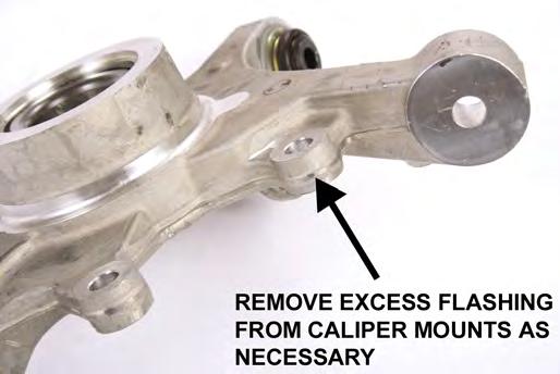 Check that the rotor can turn without any interference issues. 34. Remove the pad retaining clip from the caliper. The middle section of the clip has to be pulled upwards to clear the caliper. 38.