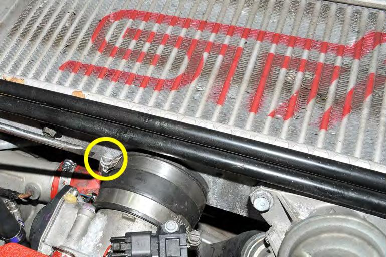7. Using a flat head screwdriver, loosen the hose clamp at the intercooler outlet silicone coupler. 8.