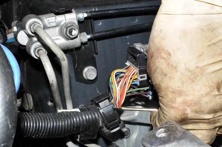 17. * 2007 STI Only - Remove the main engine harness from its mounting bracket located on the passenger side strut tower.