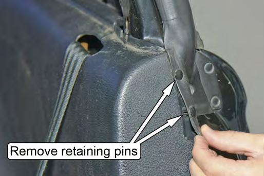 11. Remove the two small plastic retainers that are located on the forward face of the driver and passenger lower plastic