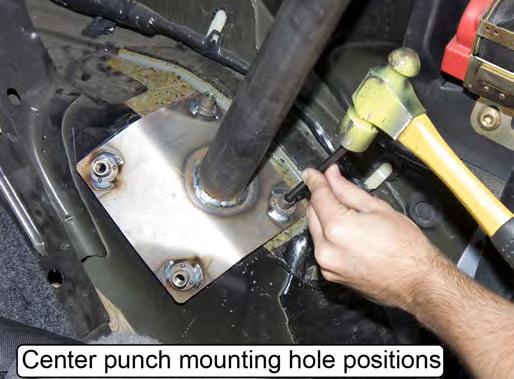 Mark the position of the four mounting holes in each rear support mounting pad onto the wheel well using a
