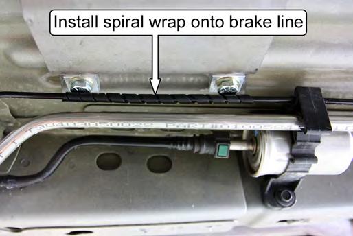 88. The outboard brake line will touch the heads of the door bar mounting hardware. Wrap the provided spiral wrap onto the brake line where it makes contact with the mounting hardware.