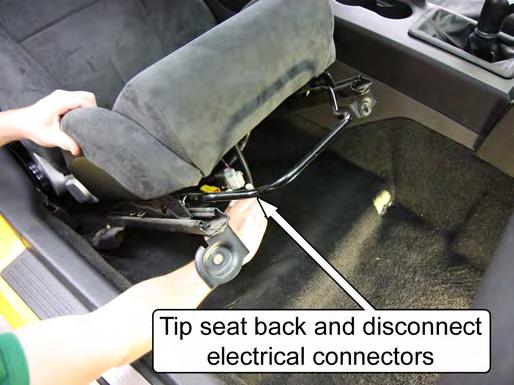 4. Tip the seat back to disconnect the wiring harness