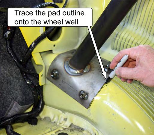 27. Trace an outline of the rear support mounting pads onto the driver- and passenger-side wheel well, and then remove the roll bar.