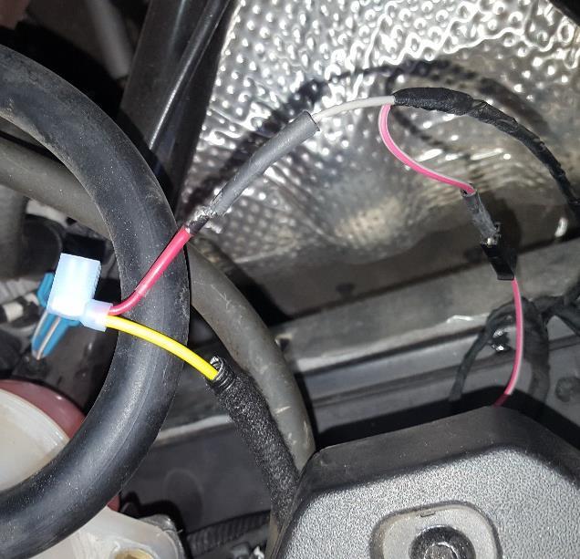 as pictured - Tuck behind Coolant reservoir - Unplug positive wire from Glove box charger port -