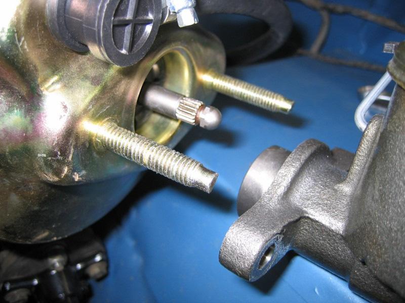 Bolt up the master cylinder: Before bolting the master cylinder to the booster you need to adjust the length of the push rod sticking out of the booster.