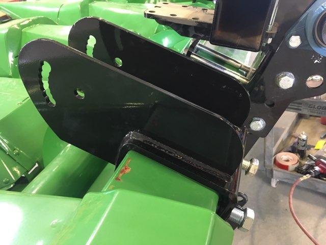 Mount the clamp assembly to the corn head. (The clamp assembly will vary depending upon the brand and model of the corn head. A John Deere clamp assembly is shown.
