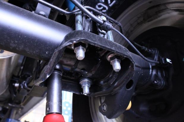 Use the floor jack to lift the rear axle, keeping the pin aligned, and install the new ubolts and hardware. 8.