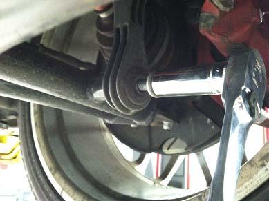 The first step is to remove the bolts for the sway bar end links using a 13mm socket.