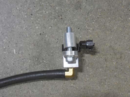 Install the provided hose assembly with the bolt and spacer from two steps ago into the