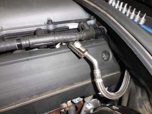109. Reinstall the left rear coil by attaching the electrical connection, spark plug wire, and then