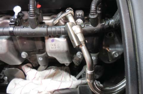 You will have to trim the left side coil cover at the point where the fuel line bracket interferes (shown
