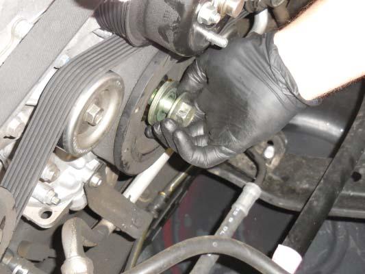 Using an impact gun, remove the bolt and washer that secures the crankshaft