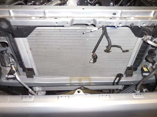 165. This photo shows the grill area with the hood support bracket removed. 166.
