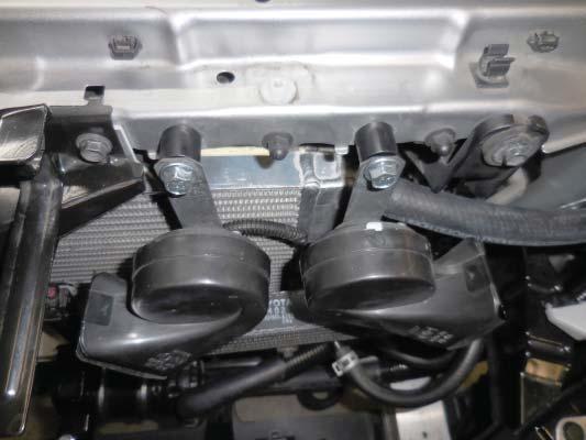 Attach the transmission oil cooler in the original locations using the