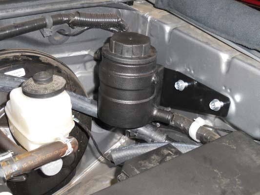 Secure the hose to the intercooler reservoir with a provided worm gear clamp.