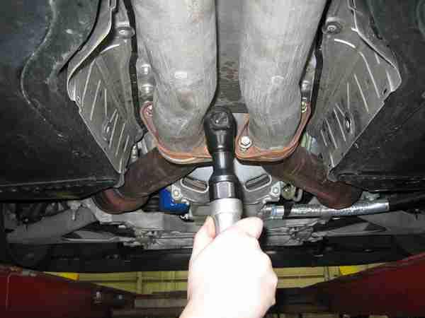 Pull the sway bar towards the rear of the car to clear the studs and rotate it down on the end links.