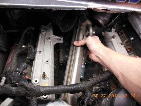 Continuing to hold the manifold up, lift and