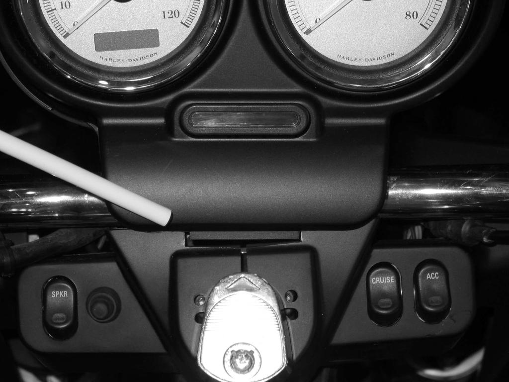 FLTR (ROAD GLIDE) You will need to remove the speedometer and tachometer instrument bezel. To do this, remove two small screws on the left and right side of the bezel.