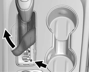 318 Vehicle Care 2. Remove the shift lever boot by pulling up on the rear of the trim plate. 3. Use a small screwdriver or tool to press and hold the manual release button on the rear right. 4.