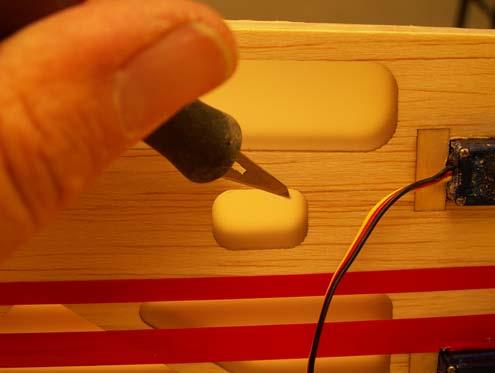 53. Use a hobby knife to remove the covering from the opening on the right