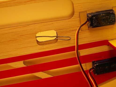 Use a short piece of safety wire or a weighted string to fish the rudder