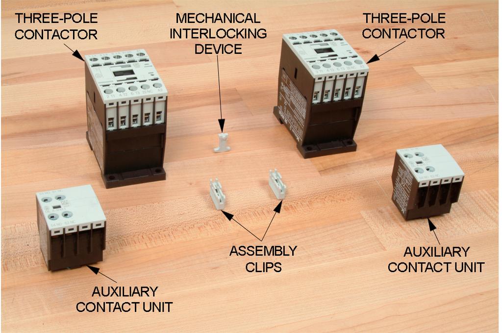 Ex. 3-4 Reversing Starters Discussion Figure 3-10. Mechanical interlocking. Refer to the circuit of Figure 3-11. A mechanical interlock (in dashed lines) is located between the two contactor coils.