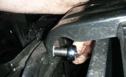Using a 10mm socket wrench, remove the two bolts on the passenger-side of the A
