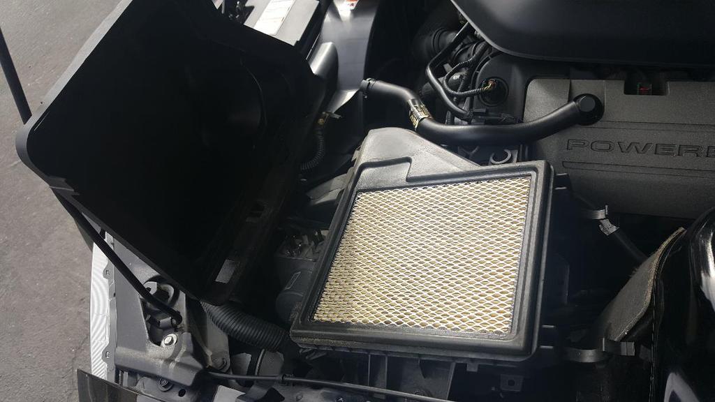 b) Open the filter compartment to expose the air filter and remove.