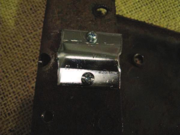 I drilled two holes in the shroud that matched the current holes in the support bracket.