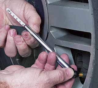 Remove the gauge and refit the valve cap. Fig 29. Using a digital pressure gauge to check tyre pressure.