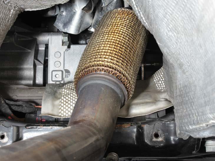 9. Unscrew the four heat protection s bolts, carefully remove the heat protection and the down pipe off the vehicle