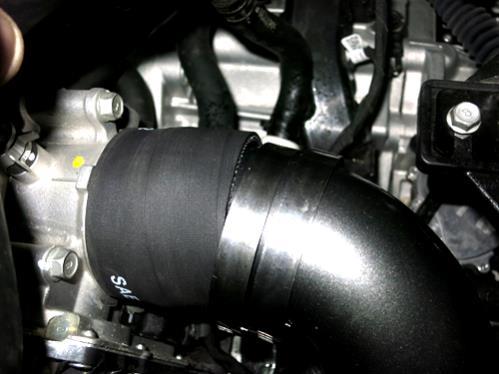 Install the 90 coupler with the provided hose clamps onto the lower intercooler outlet.
