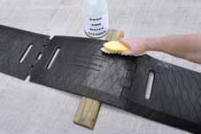 Use a brush or coarse rag to apply a generous coating of denatured alcohol to the clean tape application