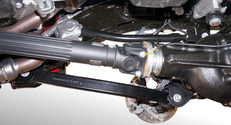 7) Remove heat shields and loosen, but do not remove, upper and lower control arm bolts. See Illustration 4. Heat Shield Upper Control Arm Driveshaft 15) Remove the shock absorber upper bolt.