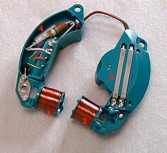 plastic "kidneys" joined by a simple pair of wires. The coils ( 1 and 2) to activate the tuning fork are integrated into the kidneys.