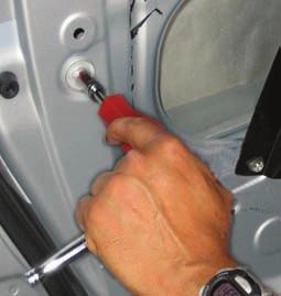 Remove the two rubber hole covers hiding the 10-millimeter bolts for