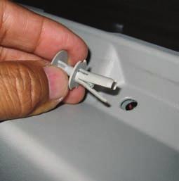 Remove the push-in plug fasteners from the top side of the trim panel using a hook and pick and