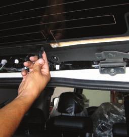 Remove the two 3 16-inch Allen-head bolts on the glass that hold the hinge, stop light, back glass window-washer nozzles and exterior wind deflector.