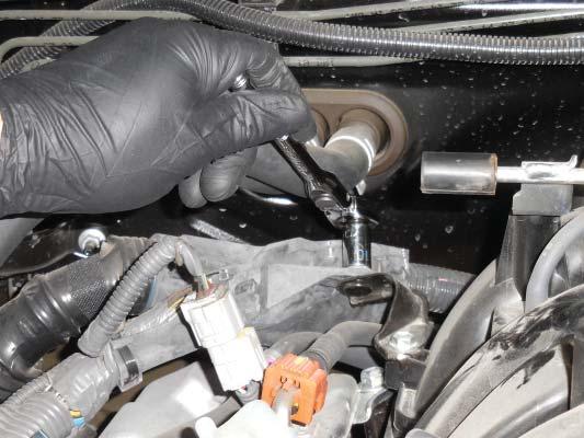35. Use a 12 mm swivel socket to remove the 2 nuts and 8 bolts holding the manifold in place.