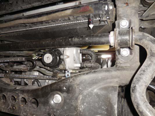 Slide the compressor away from the engine while keeping it on the 2 studs.